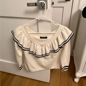 Central Park West sweater. Not sure the size but fits like a xs/s